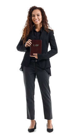 Young female judge with law book on white backgroundの写真素材