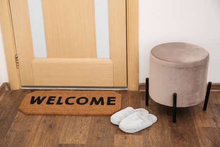 Mat with slippers and pouf near light doorの写真素材