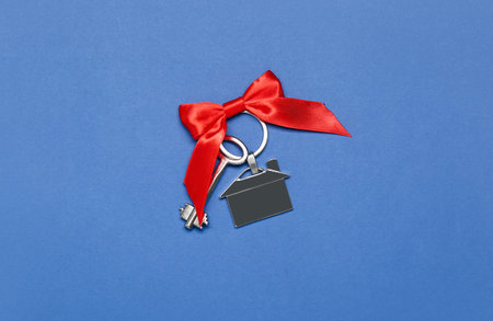 Key from new house with bow on blue backgroundの写真素材
