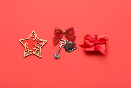 Key from new house, Christmas gift and star on red backgroundの写真素材