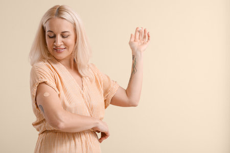 Mature woman with applied nicotine patch on color background. smoking cessationの写真素材