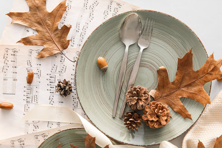 Autumn table setting and music notes on light background