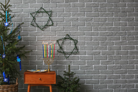 Menorah and cookies for Hanukkah celebration with Christmas trees in roomの写真素材