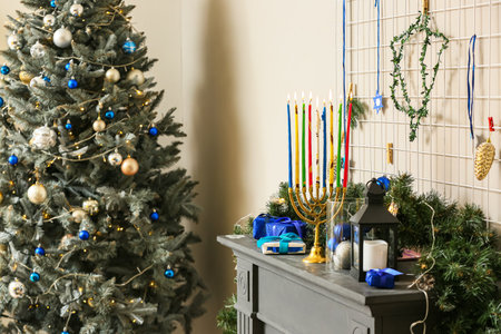 Beautiful decorations for Hanukkah celebration on fireplace in roomの写真素材