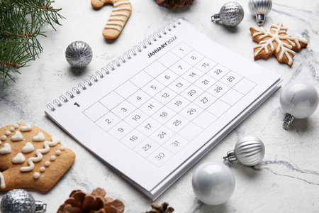 Paper calendar for January 2022, Christmas decor and cookies on light table, closeupの写真素材
