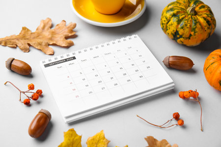 Classic flip paper calendar for September 2022, cup of coffee and autumn decor on gray background, closeupの写真素材