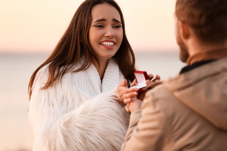 Young man proposing to his beloved girl near the river