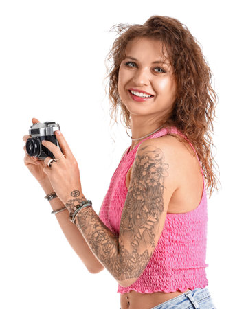 Beautiful tattooed woman with photo camera isolated on whiteの写真素材