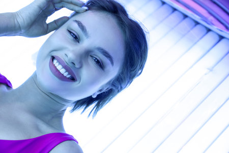 Young woman on sunbed in beauty salonの写真素材