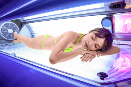 beautiful young woman on sunbedの写真素材