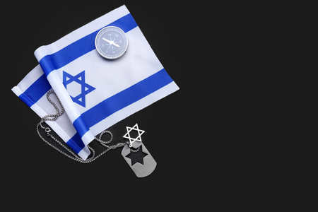 National flag of Israel, compass and military tag on dark background