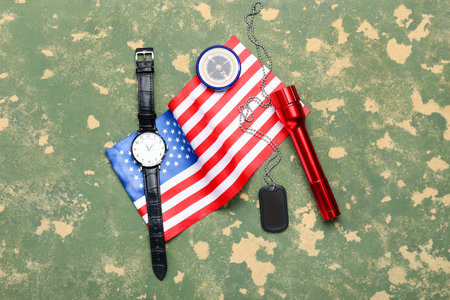 National flag of USA, military tag, wristwatch, compass and flashlight on color backgroundの写真素材