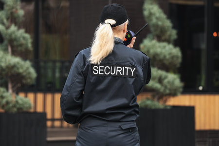 Female security guard outdoors, back viewの写真素材