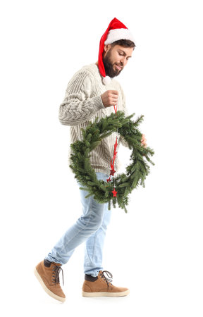 Walking man with Christmas wreath on white backgroundの写真素材