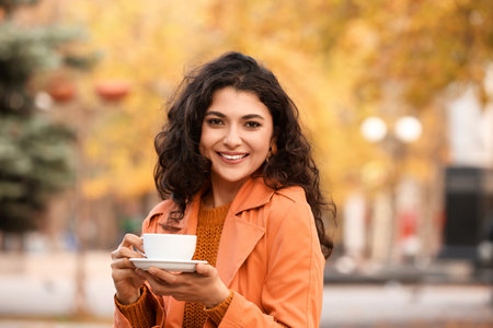 Beautiful woman drinking tea outdoors