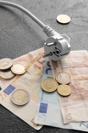 Money with plug on dark background, closeup. heating season conceptの写真素材