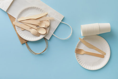 Eco tableware and paper bags on blue backgroundの写真素材