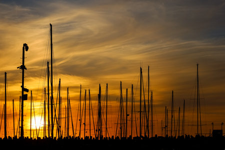 Yacht masts against sky background at sunsetの写真素材