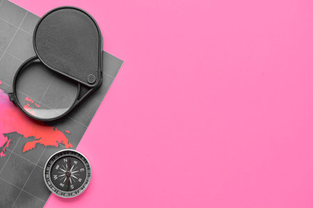 Magnifier, compass and world map on color backgroundの写真素材