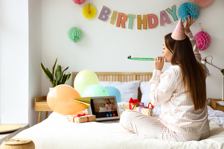 Young woman celebrating Birthday at home due to coronavirus epidemicの写真素材