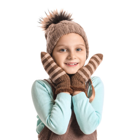 Little girl in stylish winter clothes on white backgroundの写真素材