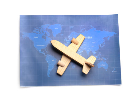 World map and wooden airplane isolated on white backgroundの写真素材