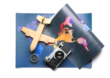 World maps, wooden airplane and photo camera isolated on white backgroundの写真素材
