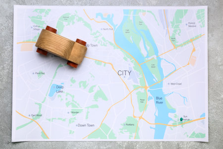 Wooden car and map on gray backgroundの写真素材