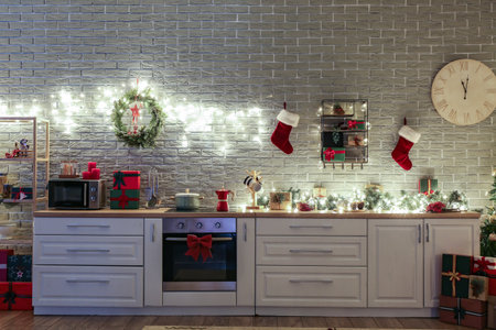 Interior of modern kitchen with Christmas decor near brick wallの写真素材