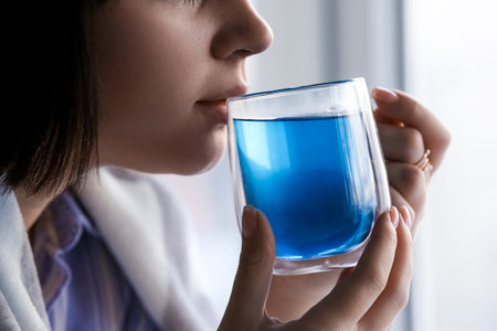 Woman drinking tasty blue tea at home, closeupの写真素材