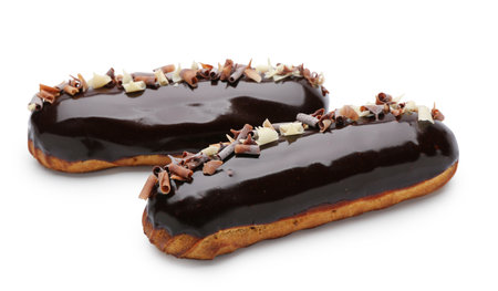 Sweet chocolate eclairs on white background