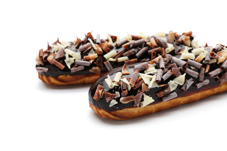 Sweet chocolate eclairs on white background