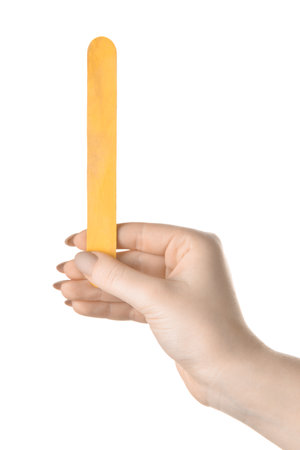 Woman holding yellow ice cream stick on white background, closeupの写真素材