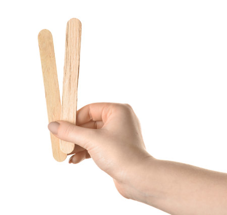 Female hand with ice cream sticks on white backgroundの写真素材