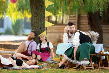 Drunk people outdoors after Octoberfest celebrationの写真素材