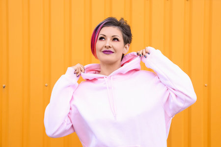 Beautiful woman with dyed hair on yellow backgroundの写真素材