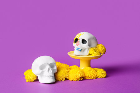 Human skulls with flowers on violet background. Mexico's Day of the Dead (El Dia de Muertos)の写真素材