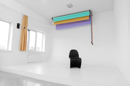 Modern black chair in light photo studio