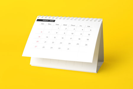 Classic flip paper calendar for March 2022 on yellow backgroundの写真素材