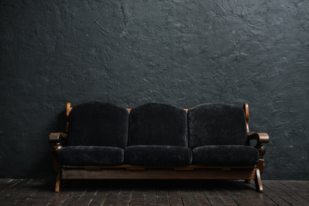 black couch near dark wall
