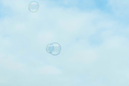 Beautiful soap bubbles on blue sky backgroundの写真素材