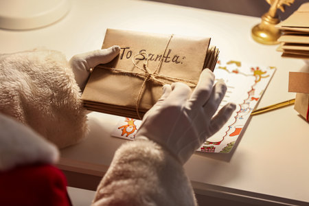Santa Claus with letters at home on Christmas eveの写真素材