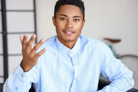 African-American man video chatting at home