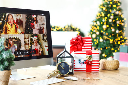 Computer on table in room. Celebration of Christmas online due to epidemicの写真素材