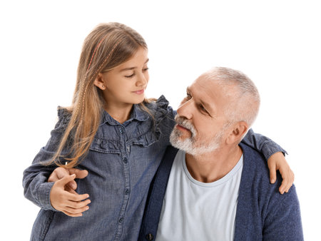 Senior man with his little granddaughter hugging on white backgroundの写真素材