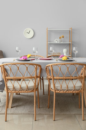 Dining table with beautiful setting and Gladiolus flowers in room interior