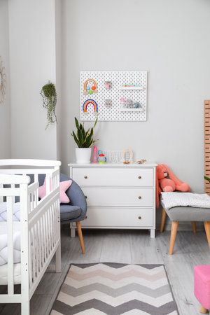 Interior of stylish children's bedroom with commode and pegboardの写真素材