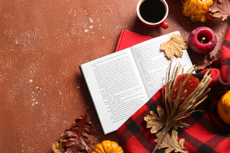 Book, cup of coffee and autumn decor on grunge backgroundの写真素材