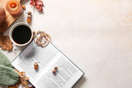 Books, cup of coffee, accessories and autumn decor on light backgroundの写真素材