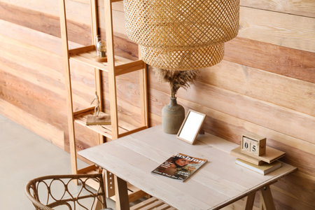 Interior of stylish room with modern workplace, shelving unit and hanging lamp